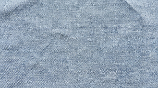 Faded blue chambray fabric texture with slubs for casual denim background