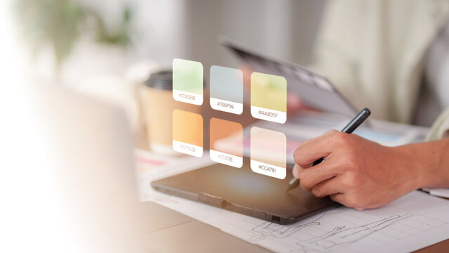 Graphic designer using stylus and digital tablet for color selection