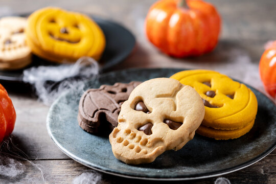 Assorted Halloween cookies on wooden table
