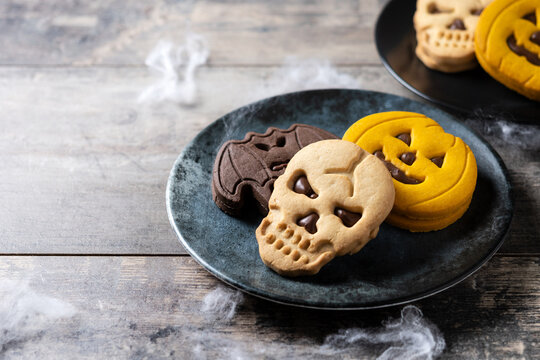 Assorted Halloween cookies on wooden table