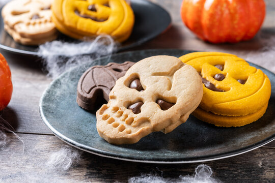 Assorted Halloween cookies on wooden table
