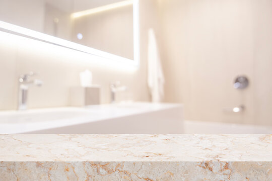 Marble empty table for product display in blurred bathroom double sink interior background