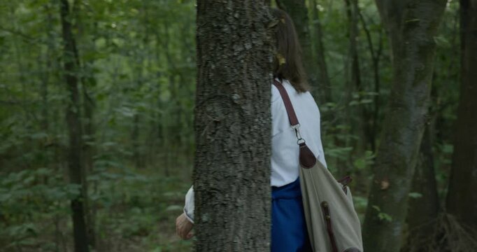 Caucasian man with long hair and Ukrainian traditional folk attire walk wandering on nature. 4K 10-bit