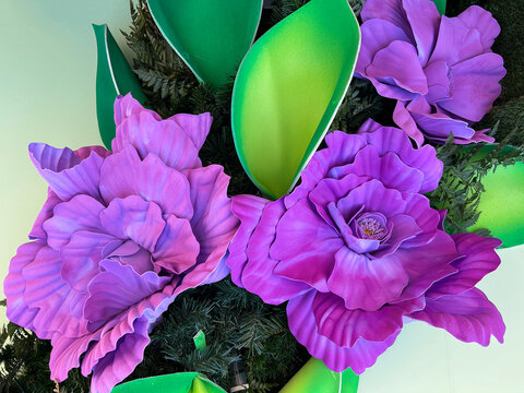 Floral background with purple artificial flowers. Close-up.
