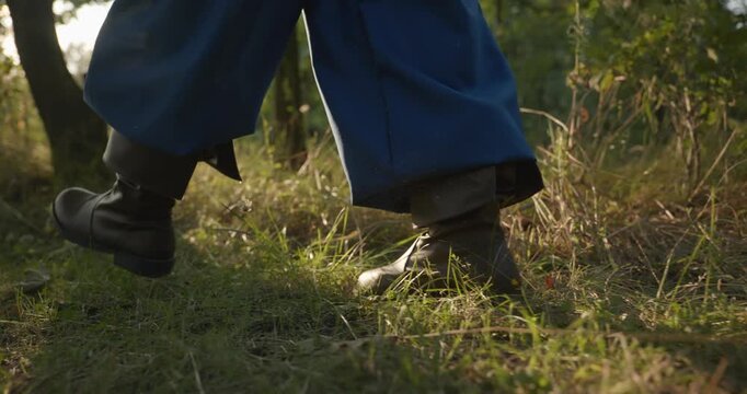 Caucasian man with long hair and Ukrainian traditional folk attire walk wandering on nature. 4K 10-bit