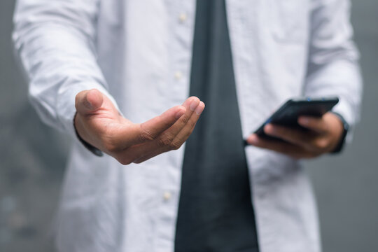 Close up of open palm hand gesture holding smartphone embodying fintech value delivery, mobile banking, digital asset management, transparent transactions, and financial inclusion