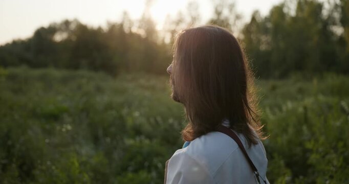 Caucasian man with long hair and Ukrainian traditional folk attire walk wandering on nature. 4K 10-bit