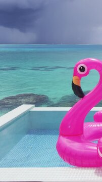 Travel vacation background video. Pool Beach Vacation travel inflatable pink flamingo float toy mattress by pool. Raw unedited vertical video.