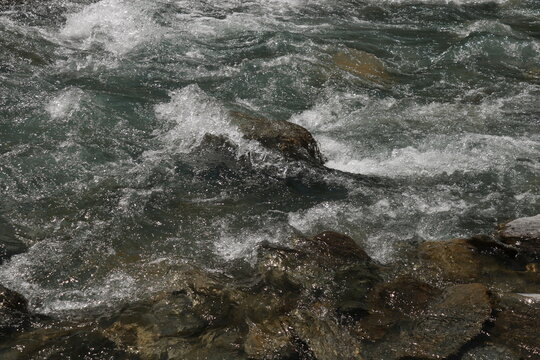 Mountain river surrounded by  majestic alpine mountains