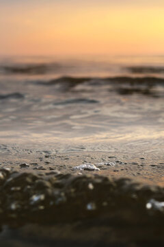sea water waves with sunset lights