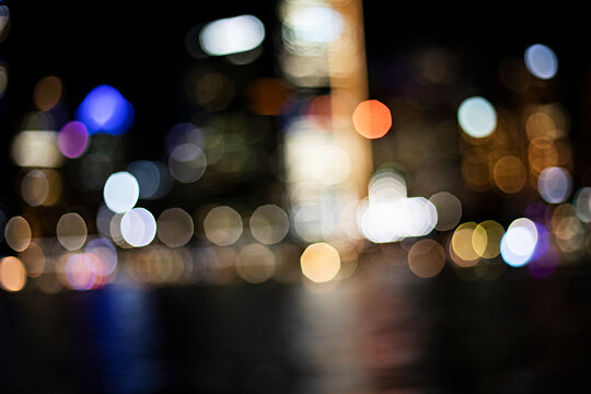 Abstract bokeh lights create a dreamy, magical atmosphere at night for background texture
