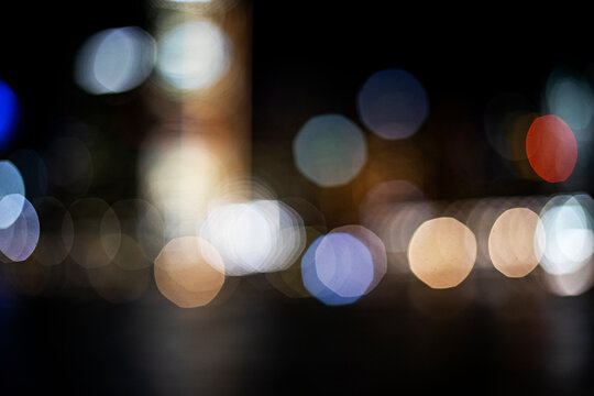 Abstract bokeh lights create a dreamy, magical atmosphere at night for background texture