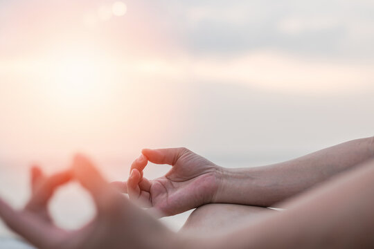 Mantra yoga meditation, spiritual mental health practice, human spirit therapy, mental balance concept with yogi person hands in lotus pose relaxing in peace silently on the sea beach