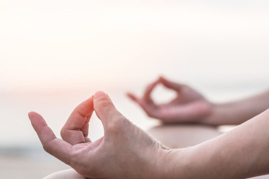 Mantra yoga meditation, spiritual mental health practice, human spirit therapy, mental balance concept with yogi person hands in lotus pose relaxing in peace silently on the sea beach