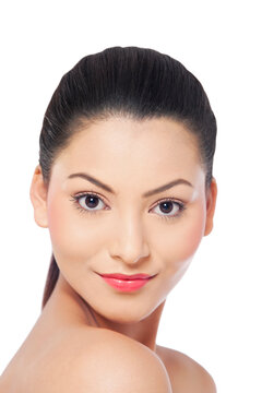 Portrait of a smiling young woman over white background 