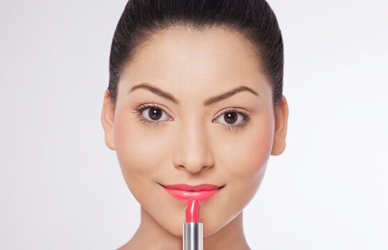 Woman applying lipstick 