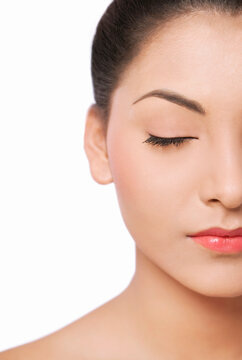 Cropped image of a smiling young woman with eyes closed 
