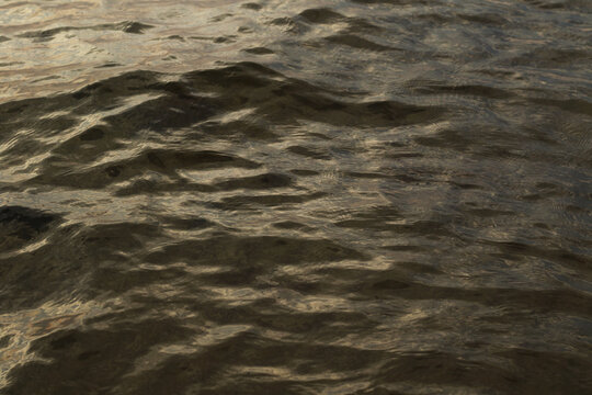 sea water waves with sunset lights