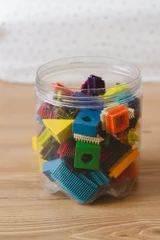 Fototapete Lego Wooden toy cars surrounded by colorful blocks on a natural floor, creating a playful setting for children's creativity.  © Анастасія Стягайло