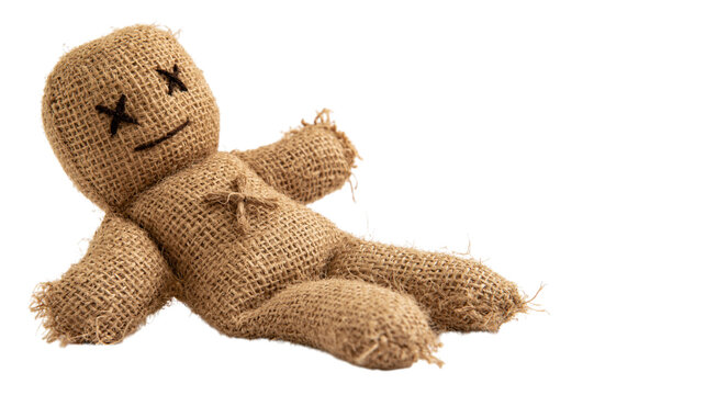 Burlap voodoo doll lying down with x eyes isolated on transparent background png cutout