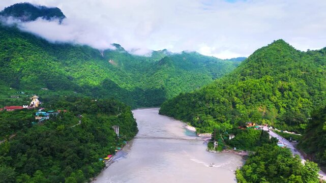 Lush Green Himalayan Mountains of Uttarakhand Covered in Monsoon Clouds and Mist, Peaceful Mountain Valley Landscape Surrounded by Dense Vegetation and Natural Beauty in India