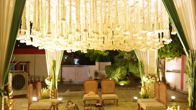 Elegant floral wedding mandap decoration with hanging white flowers for Indian ceremony.