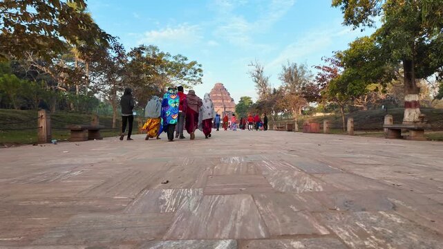 Low Angle View Of Tourists Walking On Stone Path Towards Konark Sun Temple
