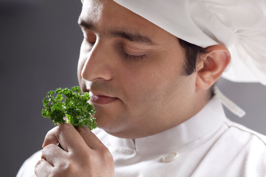 Chef smelling some herbs 