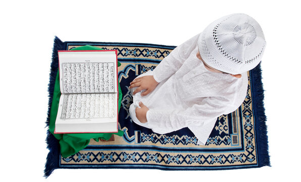 Muslim boy reading the Quran 
