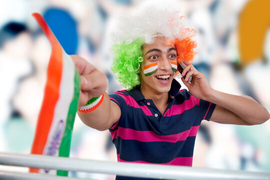 Boy talking on a phone and cheering 