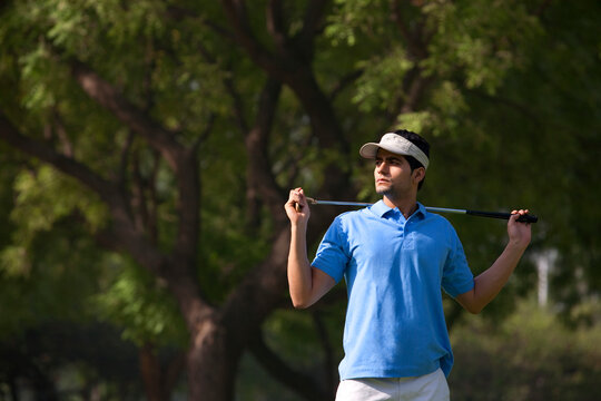 Man posing with a golf club 