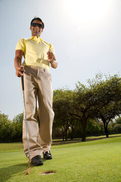 Man with a golf club and golf ball 