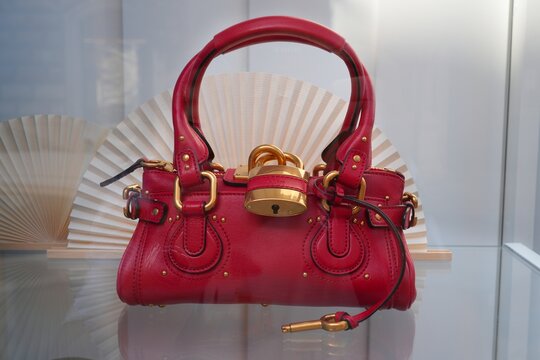 BARI, ITALY - APRIL 20, 2026: Chloe brand red leather handbag on a window store display in Bari, Italy.
