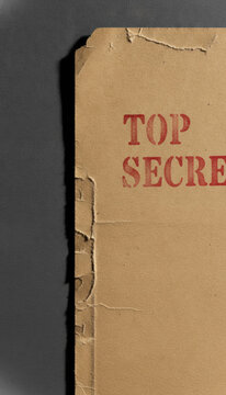Vintage Top Secret File Folder with Red Stencil Text on Weathered Paper, concept of confidentiality and classified information