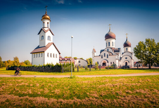 Sunny summer view of Orthodox Mykolo Apvaizdos Church with bicicle rider. Nice afternoon cityscape of Klaipeda town, Lithuania, Europe. Traveling concept background.