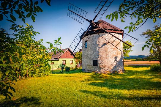 Authentic old stone Czech windmill on the countryside. Splendid summer vew of popular historical landmark in outskirts of St&iacute;pa village, Czech Republic, Europe. Traveling concept background.