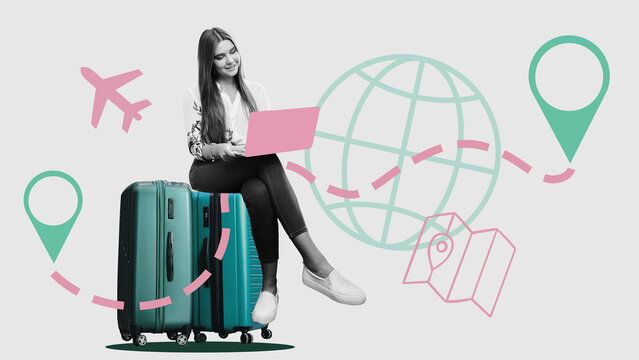 Travel planning with a laptop while sitting on a suitcase at an airport