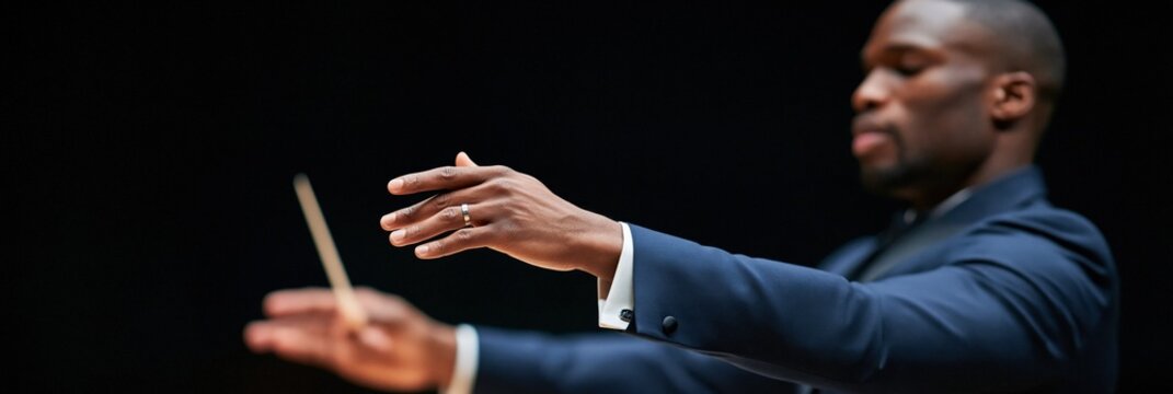 Panoramic conductor closeup with extended hands and baton in dark suit for concert banner and theatrical background design