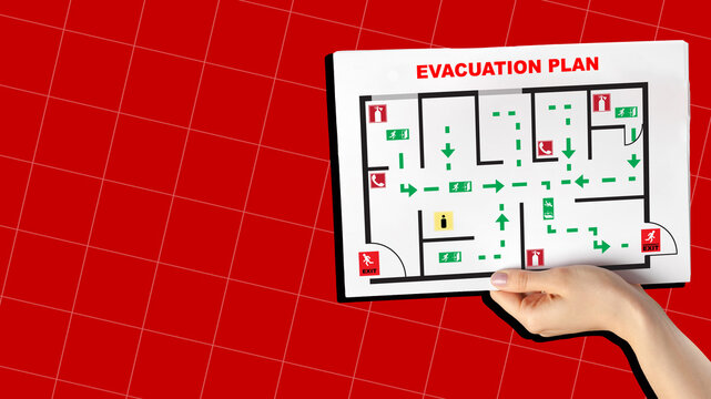 Emergency evacuation plan showing routes in a building with clear exit signs and safety instructions
