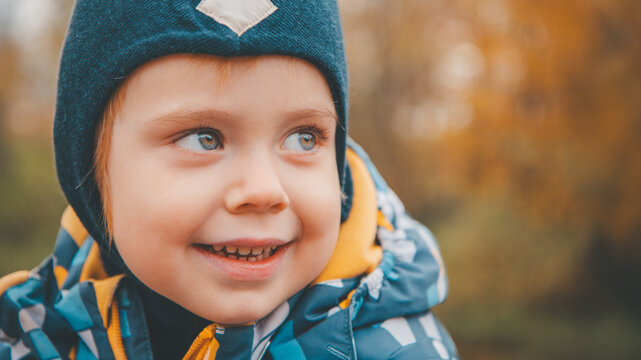 Smiling Toddler Boy in Blue Beanie Close-Up Portrait Autumn