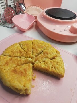 Mini instant noodles pancake on a mini pink plate 