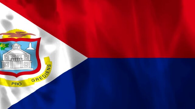 Waving flag of Saint Martin featuring the coat of arms on a white triangle with red and blue sections