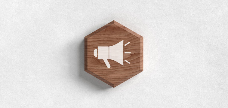 3D wooden hexagonal block with a megaphone icon on a textured white paper background, representing marketing, announcements, and communication strategies.