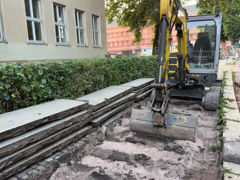New Footpath Construction with Concrete Slabs and Excavator &ndash; Urban Infrastructure and Civil Engineering Concept