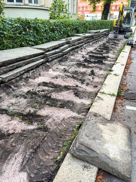 New Footpath Construction with Concrete Slabs and Excavator &ndash; Urban Infrastructure and Civil Engineering Concept Vertical
