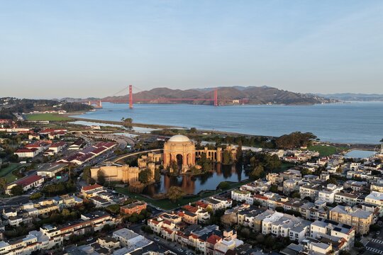 Aerial view of San Francisco's Palace of Fine Arts near the Golden Gate Bridge at golden hour. g.