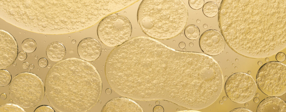 Abstract yellow water bubbles essential oil beauty collagen Serum Repair cell background.