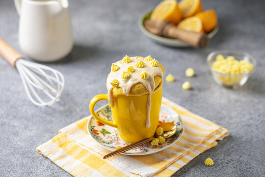 Lemon cupcake in a yellow mug. Easy homemade dessert. Mug cake
