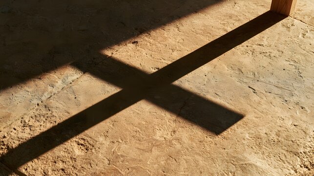 Shadow of a wooden cross cast on a stone floor