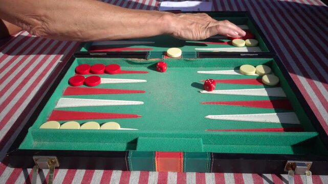 Hirtshals, Denmark Two people playing backgammon while rolling dice. 